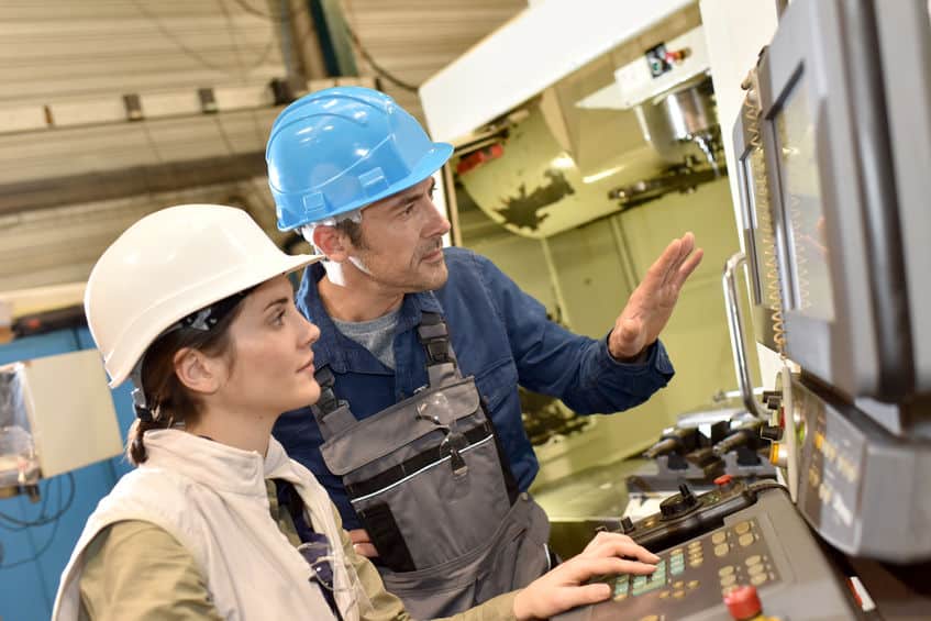 manufacturing-workers-working-on-electronic-machine