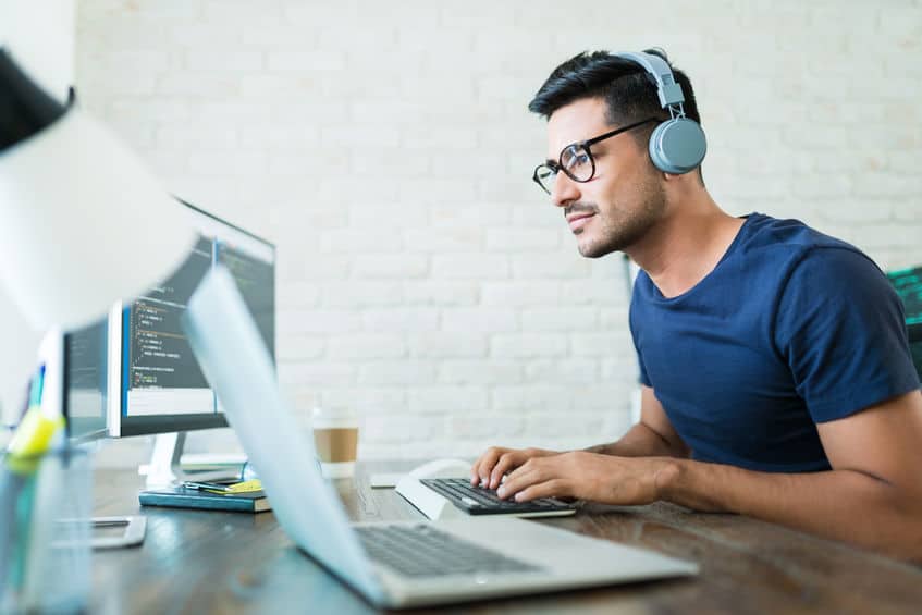 Coding Expert Using Computer At Desk