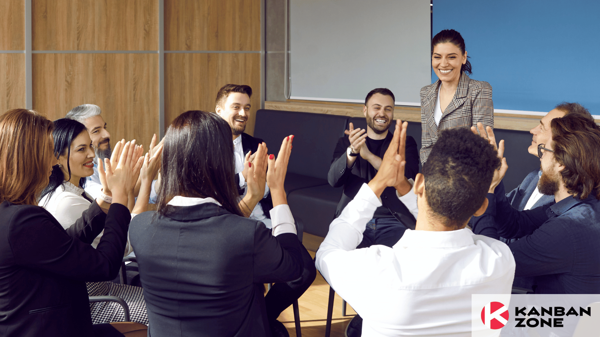 Group of happy employees giving recognition to team member