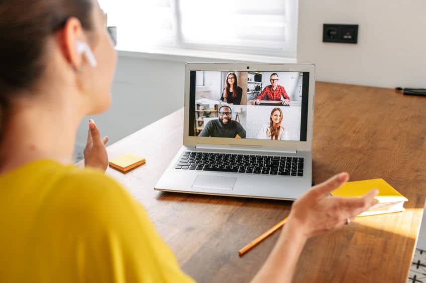 Woman uses laptop for video call indoor