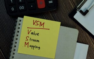 VSM - Value Stream Mapping write on sticky notes isolated on Woo
