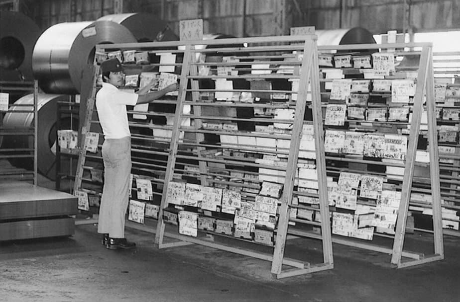 A photo of a man operating the original Kanban system developed by Toyota in their factories.