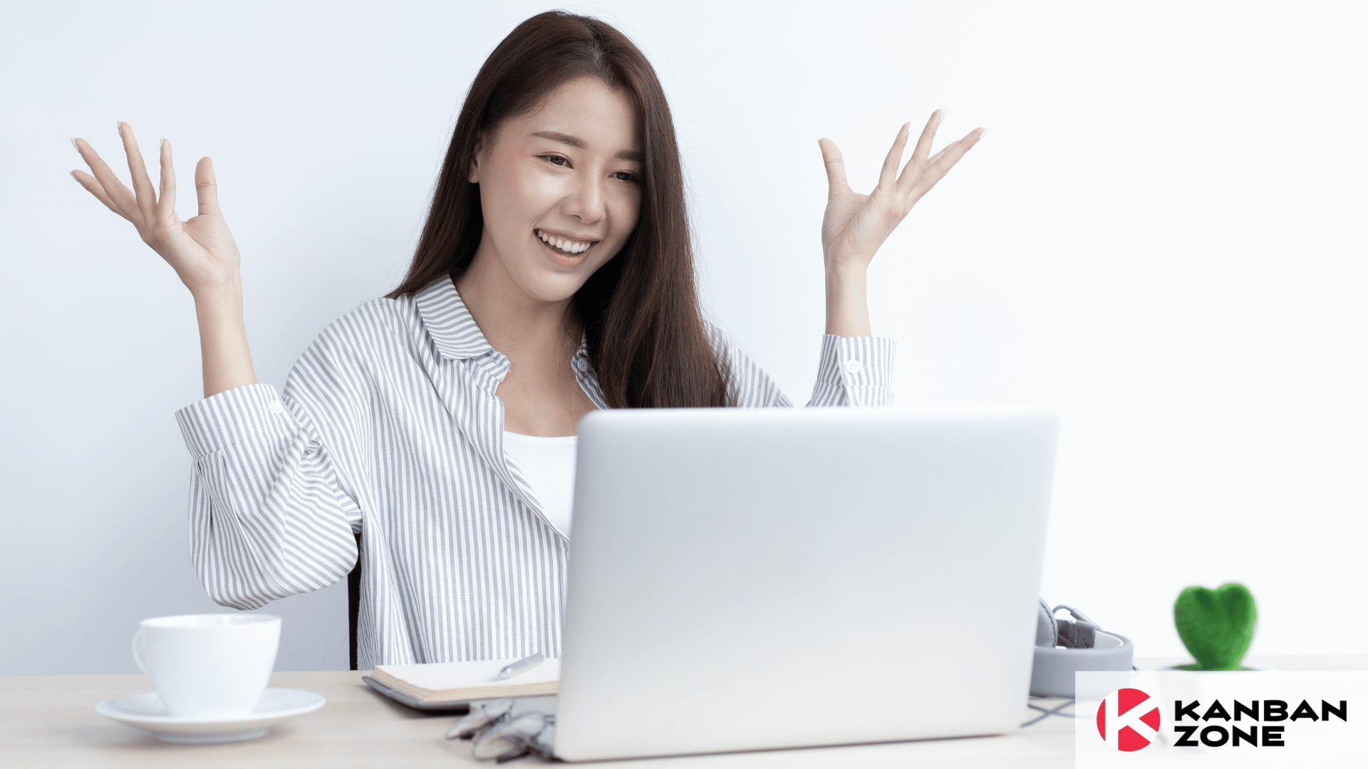 Young woman looking happy in front of laptop